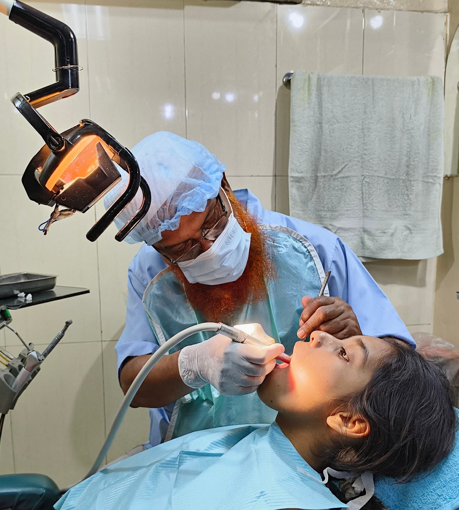 Dr. Mohammad Ali providing dental treatment at Shah Ali Dental Clinic